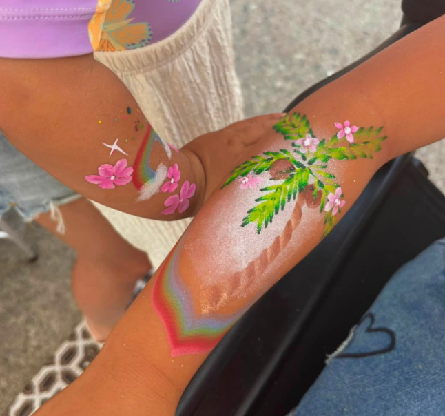 Arm painting with rainbow and fern leaves